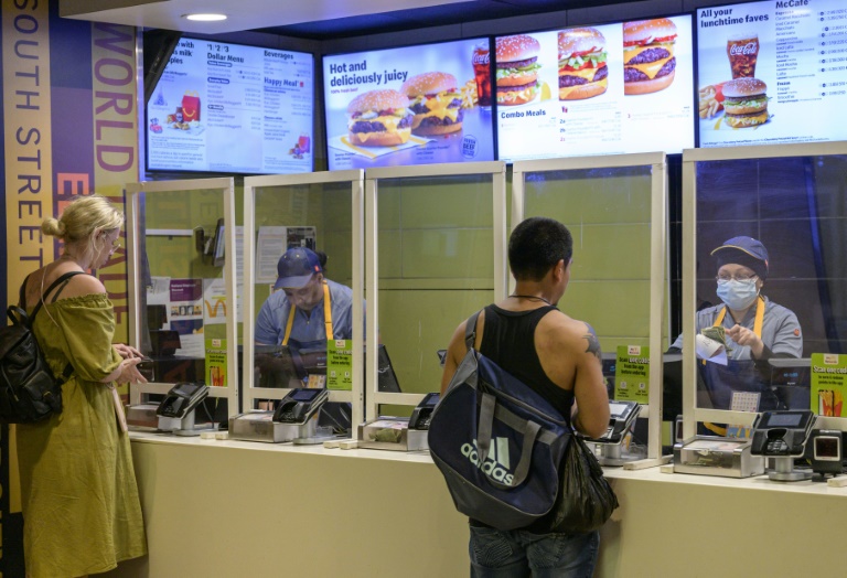 Employees at a McDonald's restaurant in New York are seen on May 27, 2022; demands by some Manhattan fast-food workers for an hourly minimum wage of $20 would once have been unthinkable