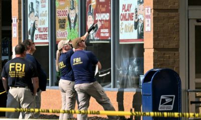 FBI agents look at bullet impacts in the Buffalo, New York grocery store where a gunman livestreamed himself shooting 13 people -- 10 of whom died