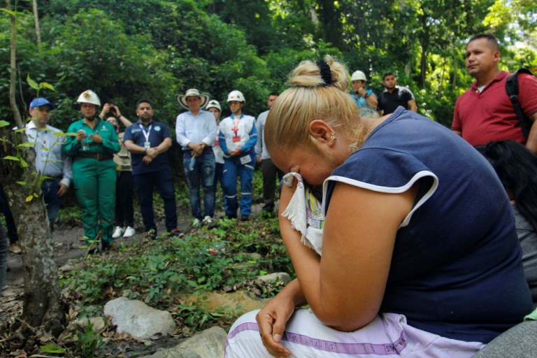 Family members gathered at the site, many in tears, waiting for news from rescue workers searching for the 14 trapped miners