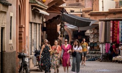 Tourists walk in the old city of Marrakesh, the city at the foot of the High Atlas mountain range