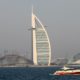 A yacht sails before the skyline of the Emirate of Dubai on April 21, 2022