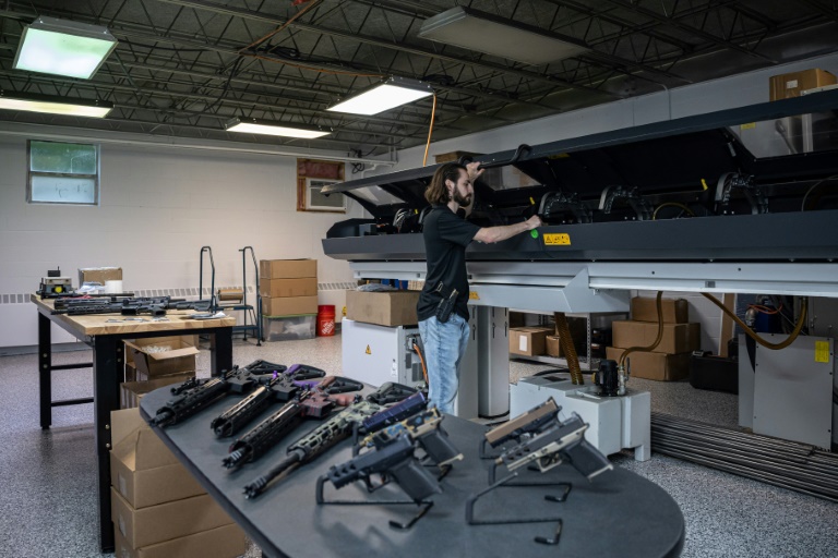 Matrix Arms owner and gun manufacturer Allen Farris checks equipment on a production line at his factory in Claremont, New Hampshire on June 3, 2022