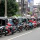 Motorists queue along a street to buy fuel at a fuel station in Colombo on June 26, 2022