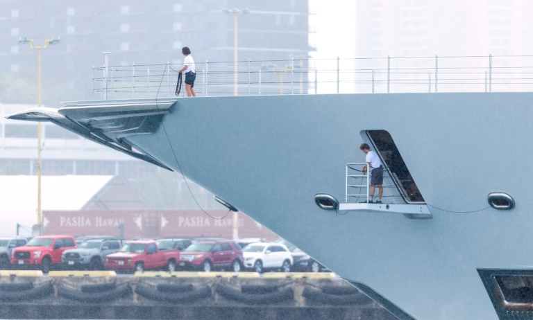 Crew members at the Honolulu harbor prepare to dock the yacht Amadea of sanctioned Russian oligarch Suleiman Kerimov, seized by the Fiji government at the request of the United States, on June 16, 2022