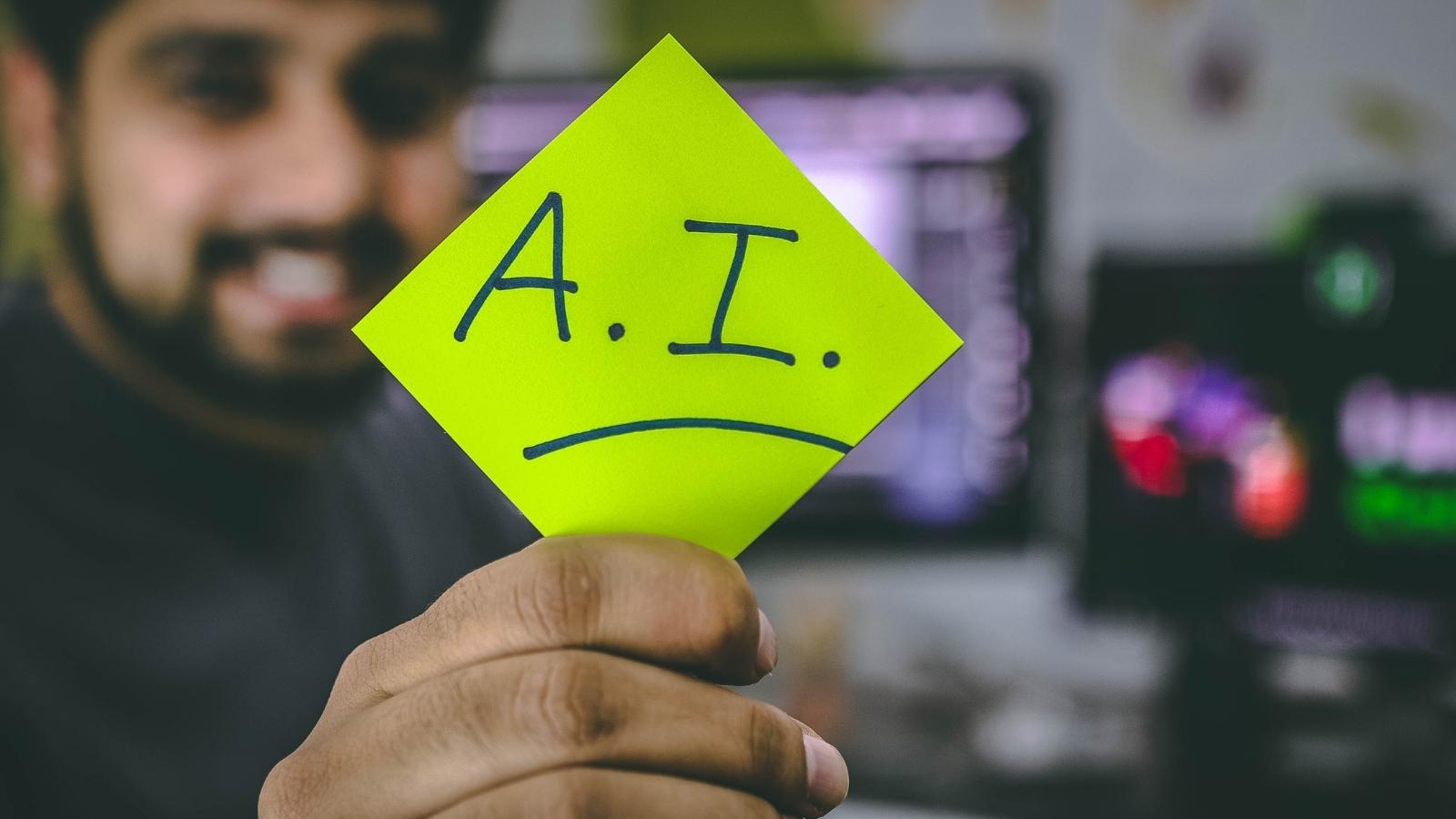 Person holding green paper photo with the letters A.I.