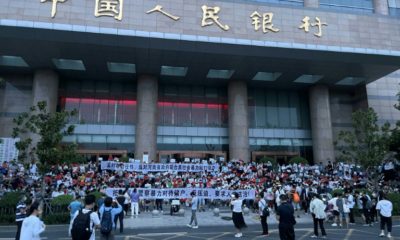 Hundreds of people rallied outside a branch of the People's Bank of China in Henan's capital Zhengzhou on Sunday demanding their money, according to multiple witnesses