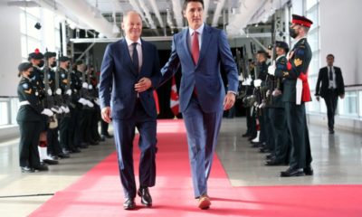 Canada's Prime Minister Justin Trudeau (R) welcomes visiting German Chancellor Olaf Scholz before their meeting at the Montreal Science Centre to discuss energy trade