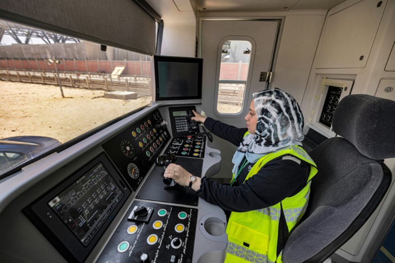 Hind Omar, shown in a full-size train simulator, is one of the first two women hired to take the controls of trains on Cairo's metro