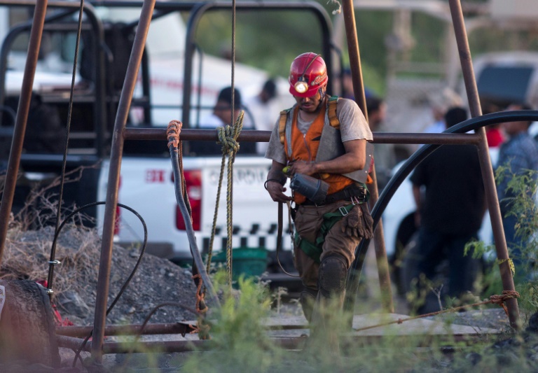 A rescuer works at a flooded coal mine in northern Mexico where 10 workers are trapped
