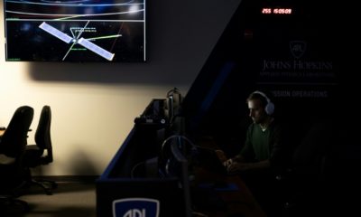 A man sits at his workstation within the Mission Operations Center for the Double Asteroid Redirection Test (DART) spaceship, which is fast approaching its target