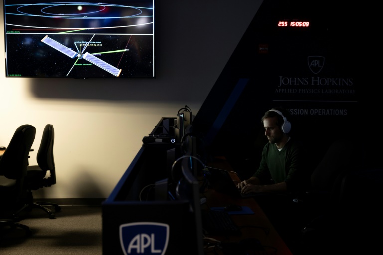 A man sits at his workstation within the Mission Operations Center for the Double Asteroid Redirection Test (DART) spaceship, which is fast approaching its target