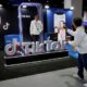 A man poses at the TikTok booth at the international media centre during the Asia-Pacific Economic Cooperation (APEC) summit in Bangkok on November 18, 2022