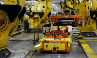 A robot lifts a battery for installation in a Ford F-150 Lightning in Dearborn, Michigan in September 2022