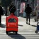 A four-wheeled robot dodges pedestrians on a street outside Tokyo, part of an experiment businesses hope will tackle labour shortages and rural isolation