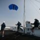 The startup Beyond The Sea tests a blue inflatable kite sail the size of a small studio to pull a specially-designed catamaran across the water