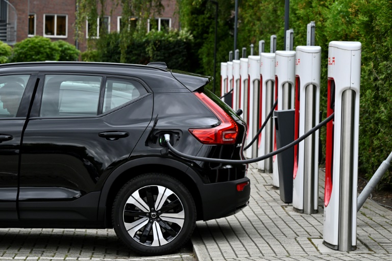 An electric car charges at a charging point reserved for Tesla cars