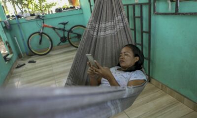 Cristina Quirino Mariano, a member of the Ticuna people, writes a message using the Linklado app in Manaus, northern Brazil