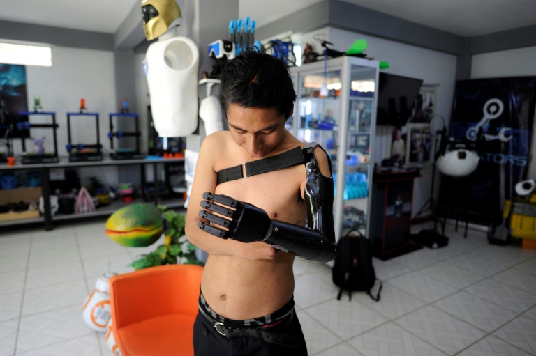 Marco Antonio Nina, 26, who lost his left arm at the age of 14 in a work accident, tests his bionic arm prosthesis that Roly Mamani made for him in his 'Robotics Creators' workshop in Achocalla, Bolivia, on January 8, 2024