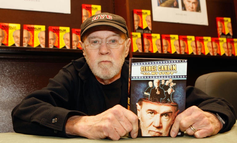 George Carlin poses with his book "All My Stuff" on December 11, 2007 in Los Angeles, California
